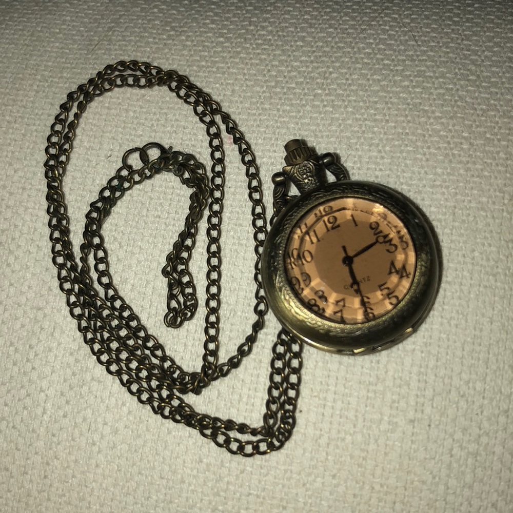 Gold watch necklace.